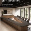 Table de conférence moderne en V dans un bureau élégant avec un éclairage naturel.