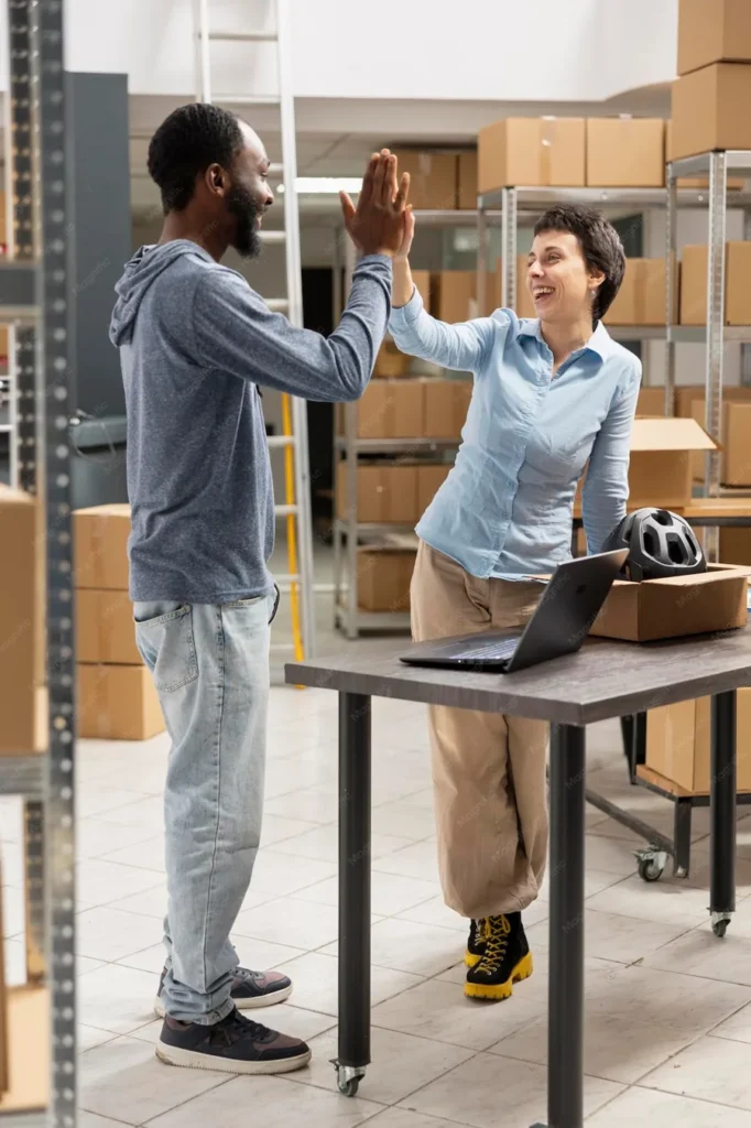 Équipe d'un hub logistique se félicitant après une expédition réussie